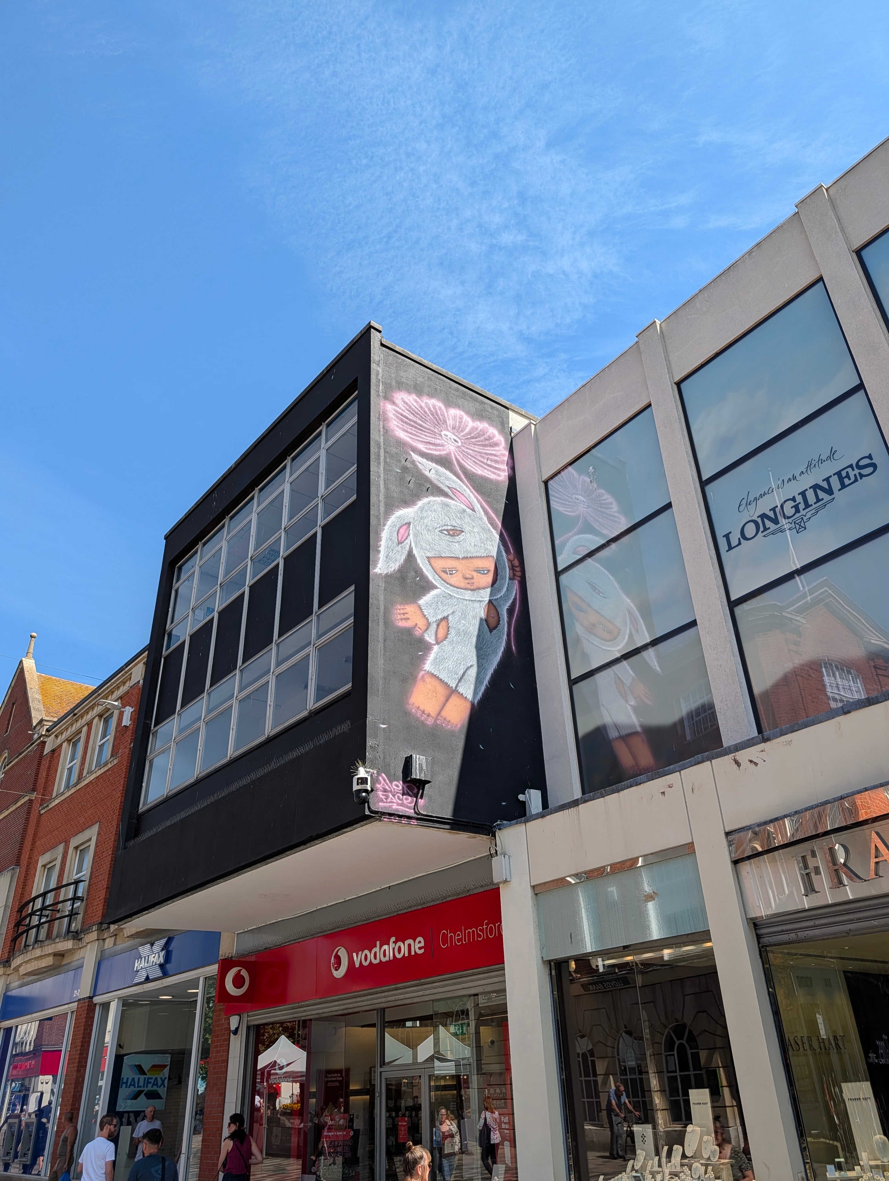 Bunny-suited child holding a flower - Chelmsford High Street